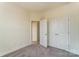 An empty bedroom features neutral walls, carpeted floors, and a closet with bi-fold doors at 2907 W Trade St, Charlotte, NC 28208