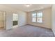Carpeted bedroom with ensuite bathroom and large window at 2907 W Trade St, Charlotte, NC 28208