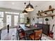 Cozy dining room with a dark wood table, leather chairs, decorative shelves, and modern lighting at 2907 W Trade St, Charlotte, NC 28208