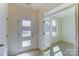 Bright entryway featuring a modern front door, white trim, and ample natural light from the adjacent room at 2907 W Trade St, Charlotte, NC 28208