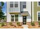Charming townhome exterior featuring light blue siding, brick accents, and a stylish black front door at 2907 W Trade St, Charlotte, NC 28208