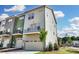 Charming two-story townhome featuring a balcony, a spacious two-car garage, and landscaped lawn at 2907 W Trade St, Charlotte, NC 28208