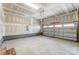 This garage features concrete floors, white walls, and an unfinished ceiling with exposed beams at 2907 W Trade St, Charlotte, NC 28208