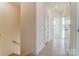 Bright hallway with light hardwood floors, and white trim, featuring multiple closets and doorways leading to various rooms at 2907 W Trade St, Charlotte, NC 28208