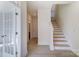 Hallway with light hardwood floors, and a staircase leading to the upper level, bathed in natural light at 2907 W Trade St, Charlotte, NC 28208