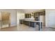 This spacious kitchen features gray cabinets, stainless appliances, and a large island with a white countertop at 2907 W Trade St, Charlotte, NC 28208