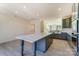 Bright kitchen with a large island, gray cabinets, and stainless steel appliances, open to the living area at 2907 W Trade St, Charlotte, NC 28208