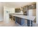 Spacious kitchen featuring a large island, gray cabinets, stainless steel appliances, and hardwood floors at 2907 W Trade St, Charlotte, NC 28208