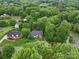 Scenic aerial view of a beautifully landscaped home nestled among mature trees in a serene neighborhood at 3015 Hamptonbrook Dr, Gastonia, NC 28056