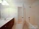 Bright bathroom with a white sink, dark wood cabinets and a shower at 3015 Hamptonbrook Dr, Gastonia, NC 28056