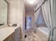 Hallway leading to bathroom with tub framed by curtains and floral wallpaper at 3015 Hamptonbrook Dr, Gastonia, NC 28056
