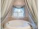Elegant bathroom with a tub with framed window at 3015 Hamptonbrook Dr, Gastonia, NC 28056