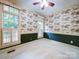 Cozy bedroom featuring neutral carpet, large windows, and unique scenic wallpaper at 3015 Hamptonbrook Dr, Gastonia, NC 28056
