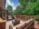 Outdoor deck with comfortable seating surrounded by lush greenery at 3015 Hamptonbrook Dr, Gastonia, NC 28056