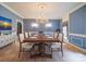 Elegant dining room with a wooden table, cream chairs, and wood floors at 3015 Hamptonbrook Dr, Gastonia, NC 28056