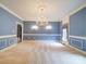 Elegant dining room with blue walls, carpet and classic chandelier at 3015 Hamptonbrook Dr, Gastonia, NC 28056