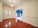 Classic foyer features gleaming hardwood floors, neutral walls, and decorative molding with access to other rooms at 3015 Hamptonbrook Dr, Gastonia, NC 28056