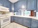 Charming kitchen featuring blue cabinets and a white oven at 3015 Hamptonbrook Dr, Gastonia, NC 28056