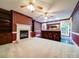 A living room with a fireplace, built-in shelving, and bar area at 3015 Hamptonbrook Dr, Gastonia, NC 28056
