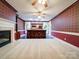 Cozy living area featuring a fireplace, bar, and carpet flooring at 3015 Hamptonbrook Dr, Gastonia, NC 28056