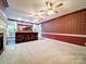 Spacious living room features carpet, bar area, and ceiling fans at 3015 Hamptonbrook Dr, Gastonia, NC 28056