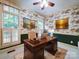 Traditional office space with a hardwood desk, ceiling fan, and an elegant patterned wallpaper at 3015 Hamptonbrook Dr, Gastonia, NC 28056