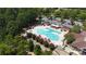 Aerial view of community pool and clubhouse surrounded by trees and a parking area at 31470 Royal Tern Ln, Indian Land, SC 29707