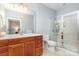 Bathroom featuring wooden vanity, white countertop, and glass-enclosed shower at 31470 Royal Tern Ln, Indian Land, SC 29707