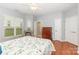 Bright bedroom featuring hardwood floors, a ceiling fan, and a view to a walk-in closet at 31470 Royal Tern Ln, Indian Land, SC 29707
