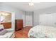 Bedroom with hardwood floors, closet space, and ensuite bath with vanity at 31470 Royal Tern Ln, Indian Land, SC 29707