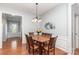 Dining room with hardwood floors, dining table, and entryway view at 31470 Royal Tern Ln, Indian Land, SC 29707