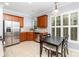 Bright kitchen features stainless steel appliances, a breakfast table and white shuttered windows at 31470 Royal Tern Ln, Indian Land, SC 29707