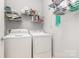 Organized laundry room with shelving and modern washer and dryer units at 31470 Royal Tern Ln, Indian Land, SC 29707