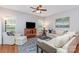 Bright living room featuring hardwood floors, neutral-toned furniture, and ample natural light at 31470 Royal Tern Ln, Indian Land, SC 29707