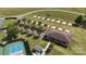 Aerial view of pickleball courts, a picnic area, and a recreation building surrounded by mature landscaping at 31470 Royal Tern Ln, Indian Land, SC 29707
