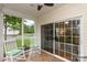 Relaxing screened-in porch with tile flooring, two rocking chairs, and view of the outdoors at 31470 Royal Tern Ln, Indian Land, SC 29707
