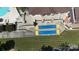 Overhead view of blue and yellow shuffleboard courts with seating near the pool and clubhouse at 31470 Royal Tern Ln, Indian Land, SC 29707
