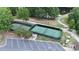 Aerial view of community tennis courts with parking, lush trees, and an adjacent walking path at 31470 Royal Tern Ln, Indian Land, SC 29707