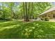 Lush backyard featuring mature trees and well-maintained lawn at 4025 Cherrybrook Dr, Mint Hill, NC 28227