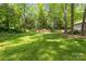 Expansive backyard showcasing lush greenery, mature trees, and privacy at 4025 Cherrybrook Dr, Mint Hill, NC 28227