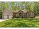 Stunning brick home featuring a two-car garage, mature trees, and manicured lawn at 4025 Cherrybrook Dr, Mint Hill, NC 28227
