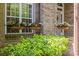 Close-up of flower boxes adding charm to the brick exterior by the large window at 4025 Cherrybrook Dr, Mint Hill, NC 28227
