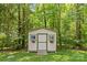 Storage shed in backyard with windows and flower boxes at 4025 Cherrybrook Dr, Mint Hill, NC 28227