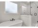 A luxurious white bathtub with a shower showcases a clean and modern bathroom design at 4095 Kingfisher Dr, York, SC 29745