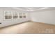 A bright and airy bedroom with light wood floors and a large window offering natural light at 4095 Kingfisher Dr, York, SC 29745