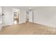 Light-filled bedroom, featuring hardwood floors, showcases a clean aesthetic leading into a bathroom at 4095 Kingfisher Dr, York, SC 29745