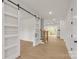 Inviting entryway showcasing a modern sliding barn door and open staircase at 4095 Kingfisher Dr, York, SC 29745