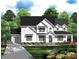 Charming two-story modern farmhouse with board and batten siding, black trim, and a covered porch at 4095 Kingfisher Dr, York, SC 29745