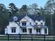 Stunning two-story home with inviting front porch and meticulous details, set against a backdrop of mature trees at 4095 Kingfisher Dr, York, SC 29745
