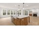 Kitchen island featuring white countertops, a farmhouse sink, stainless steel appliances, and pendant lighting at 4095 Kingfisher Dr, York, SC 29745